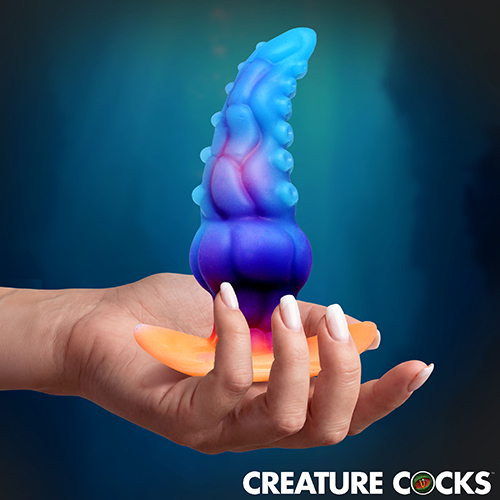 The GLOWTOPUS is a glow-in-the-dark silicone anal plug shaped like a thick tentacle with sculpted ridges, suckers, and alien textures that stimulate on insertion and during extended wear.